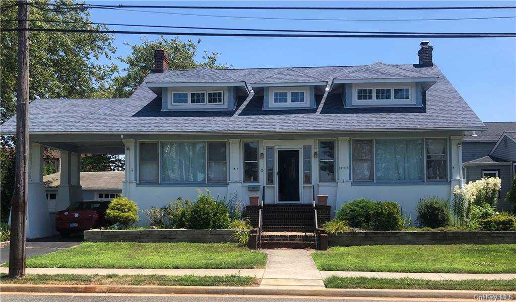 403 Roosevelt Avenue Freeport, NY 11520 - Photo 1 of 1 a front view of a house with garden