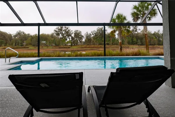 a view of a room with a table and chairs