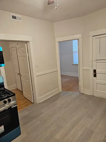 a kitchen with granite countertop white cabinets and a sink