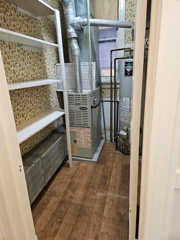 a view of a chair and table in backyard of the house