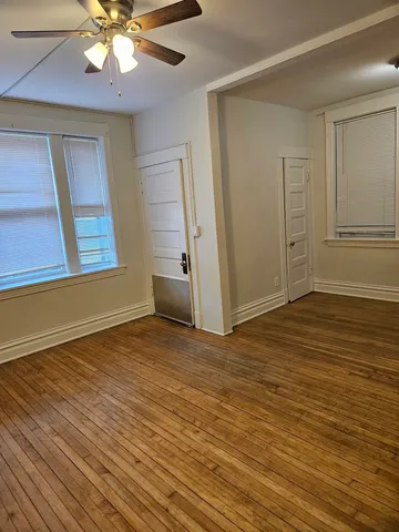 a bathroom with a granite countertop sink and a toilet