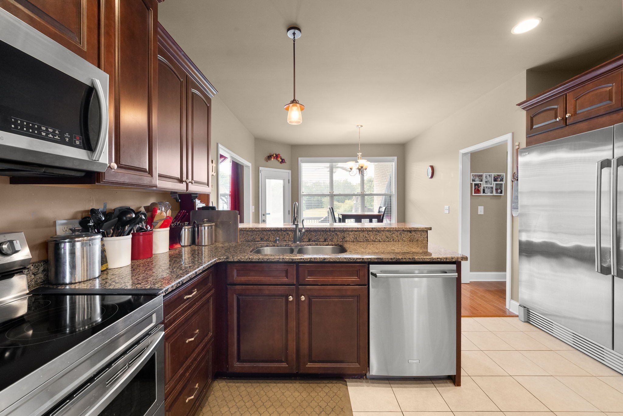 4940 Marion Road Cunningham, TN 37052 - Photo 10 of 43 a kitchen with granite countertop stainless steel appliances and wooden cabinets