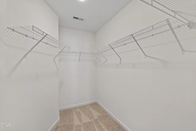 a bathroom with a granite countertop sink a large mirror and a toilet