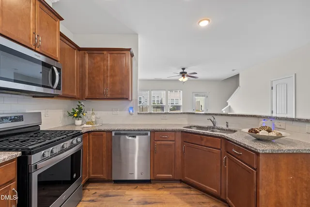 a view of empty room with wooden floor and potted plant