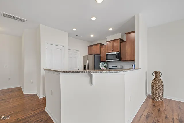a stove top oven sitting inside of a kitchen