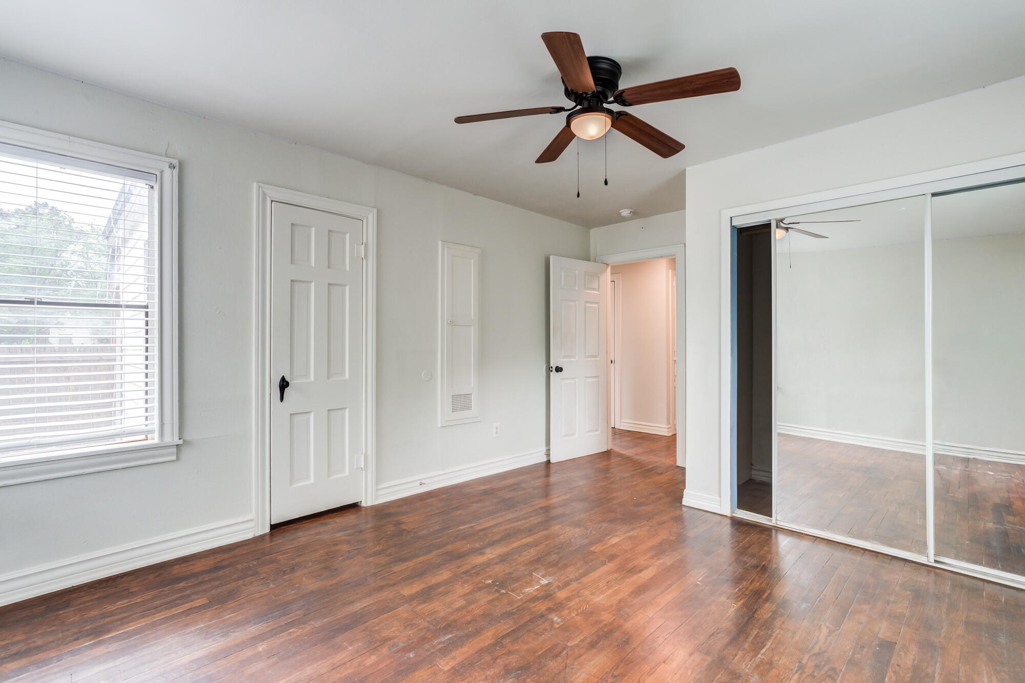 2308 30th Street Lubbock, TX 79411 - Photo 17 of 21 a view of empty room with wooden floor and ceiling fan