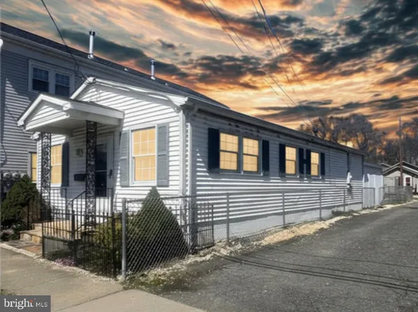 a view of a house with a wooden fence