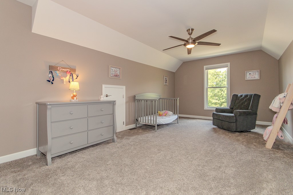 8675 Auburn Road Chardon, OH 44024 - Photo 25 of 35 Bedroom with light colored carpet, a nursery area, ceiling fan, and vaulted ceiling