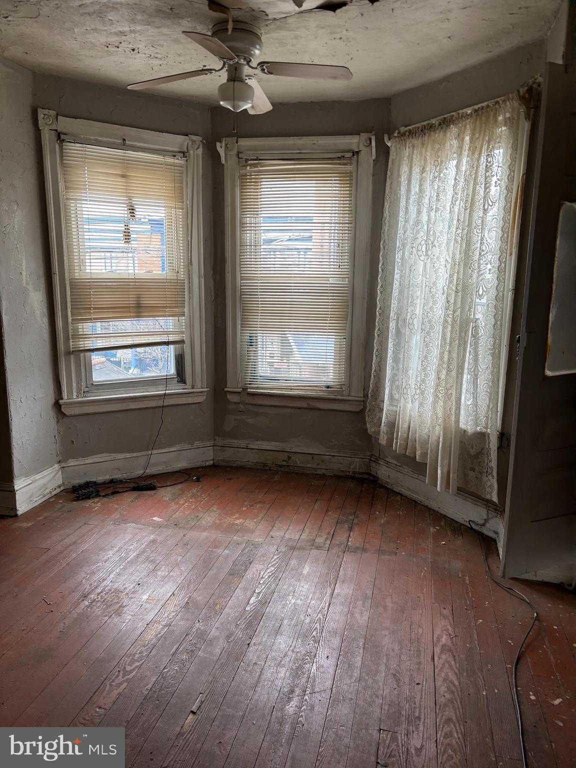 826 State Street Camden, NJ 08102 - Photo 8 of 13 an empty room with wooden floor and windows