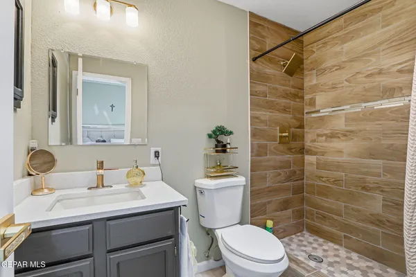 a bathroom with a sink toilet and shower