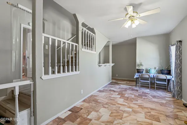 a view of a livingroom with furniture and chandelier fan