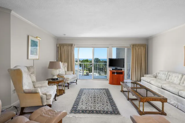 a room with kitchen island stainless steel appliances a sink and a dining table view