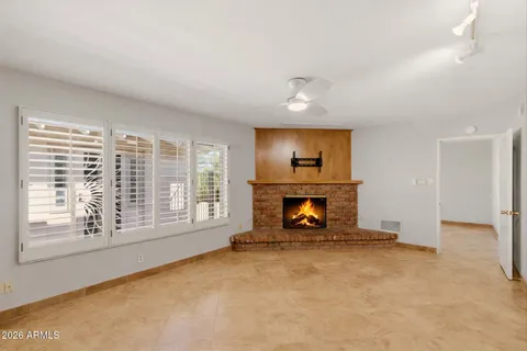 an empty room with furniture and a fireplace