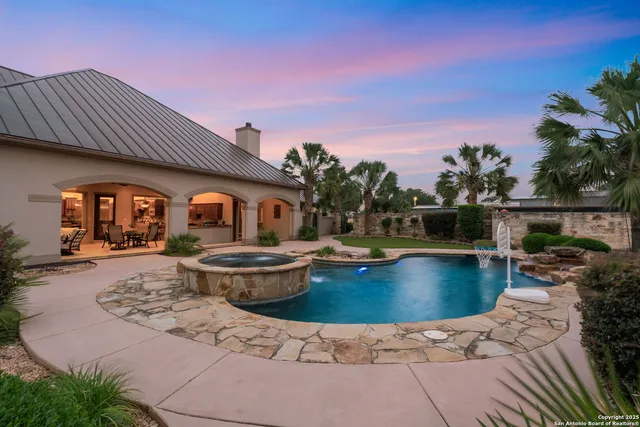 a swimming pool with outdoor seating and yard