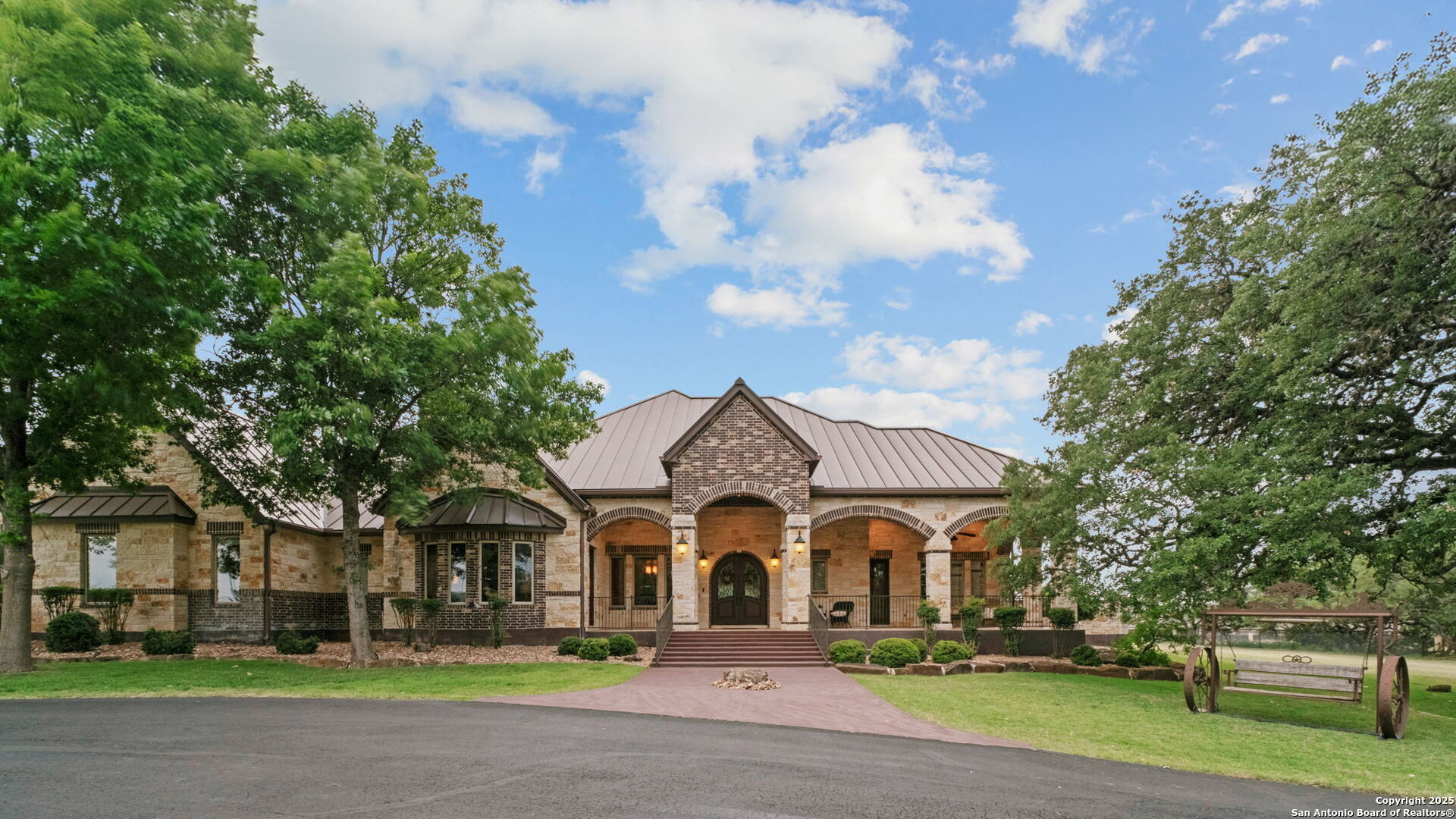 208 Cascade Caverns Road Boerne, TX 78015 - Photo 18 of 74 a front view of a house with a garden