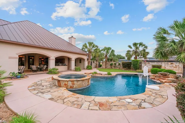 a kitchen with stainless steel appliances granite countertop a sink and a refrigerator