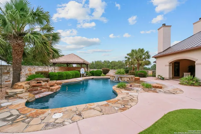 a kitchen with kitchen island granite countertop a sink appliances and cabinets