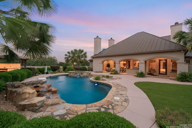 a view of a house with backyard and sitting area