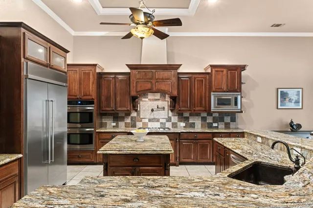 an aerial view of a house with a garden and lake view