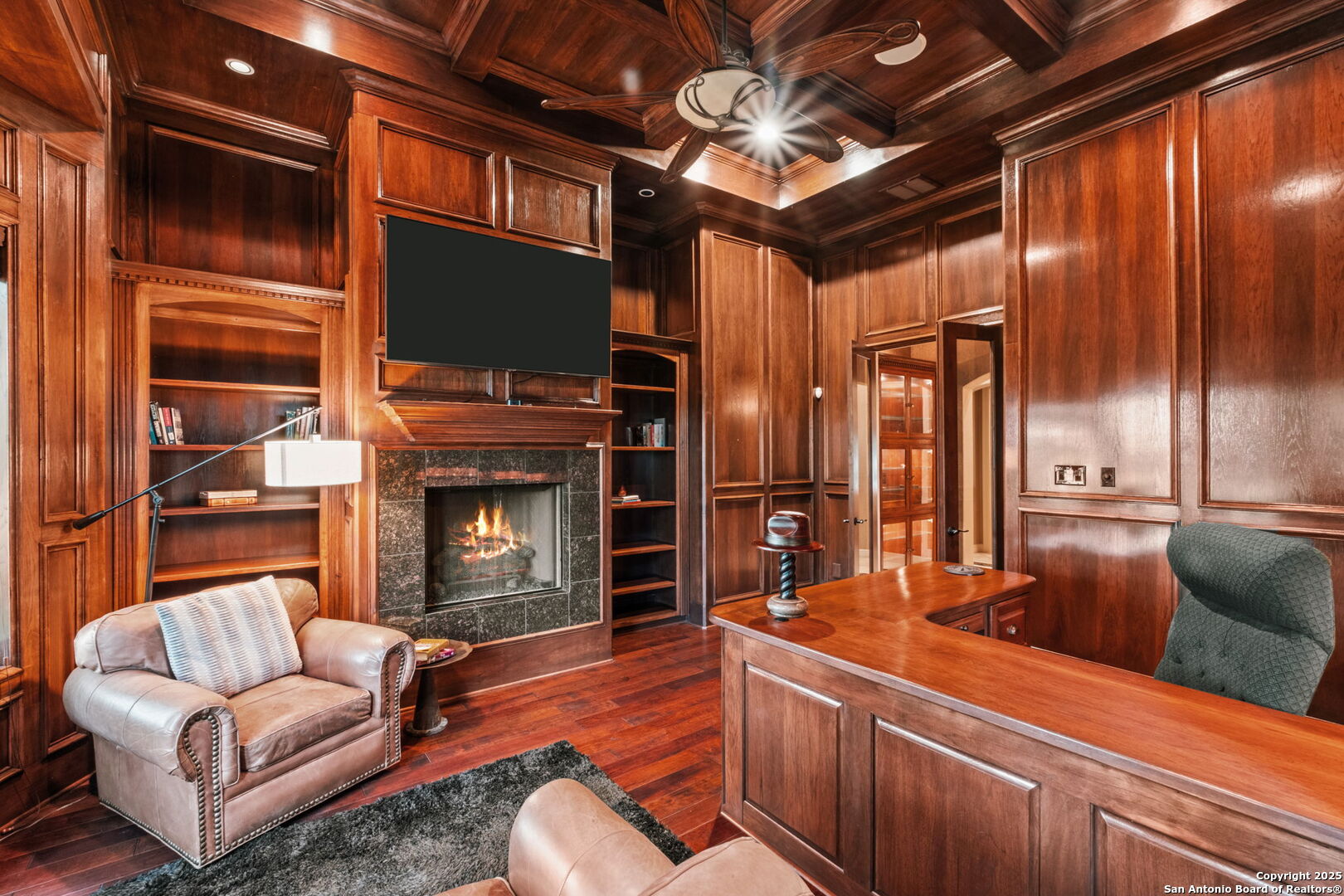 208 Cascade Caverns Road Boerne, TX 78015 - Photo 56 of 74 a living room with furniture a fireplace and a flat screen tv