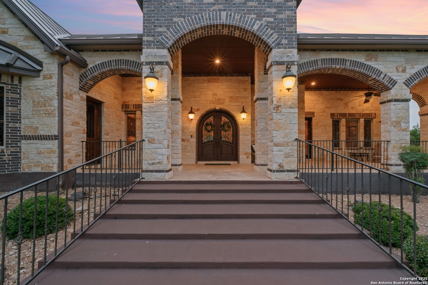 208 Cascade Caverns Road Boerne, TX 78015 - Photo 6 of 74 a view of a entrance gate of a house with a fountain
