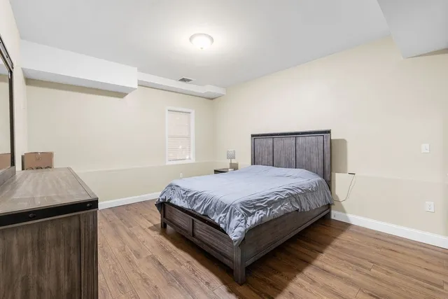 a bedroom with a bed and a dresser