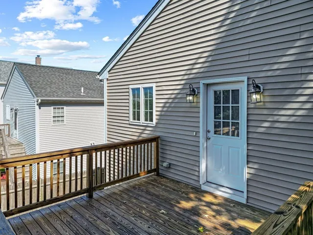 a view of a house with wooden deck