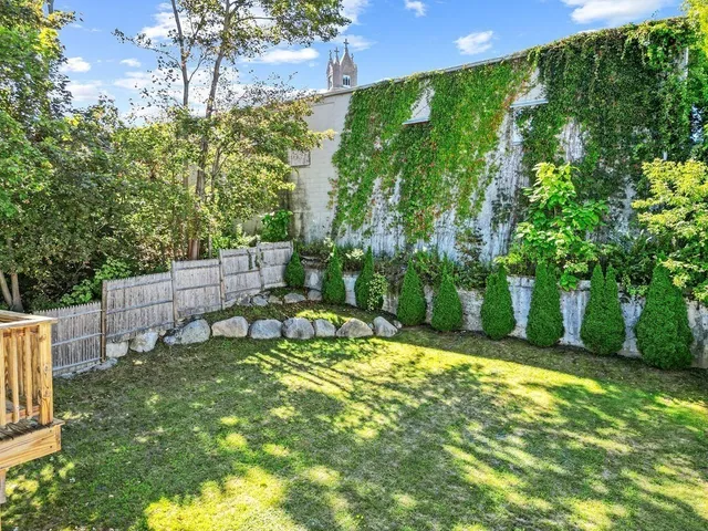 a view of a chair and table in the backyard