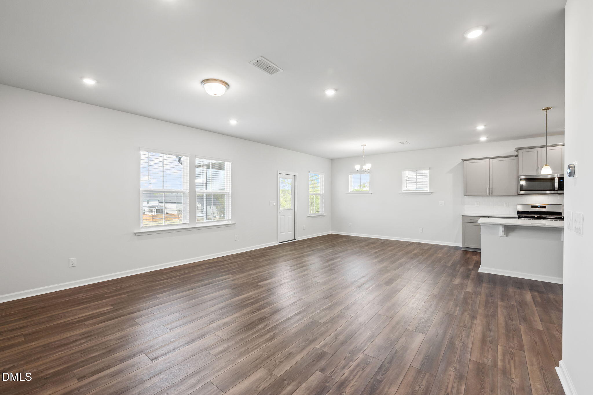 701 Mayfly Way Durham, NC 27703 - Photo 16 of 50 an empty room with wooden floor and windows