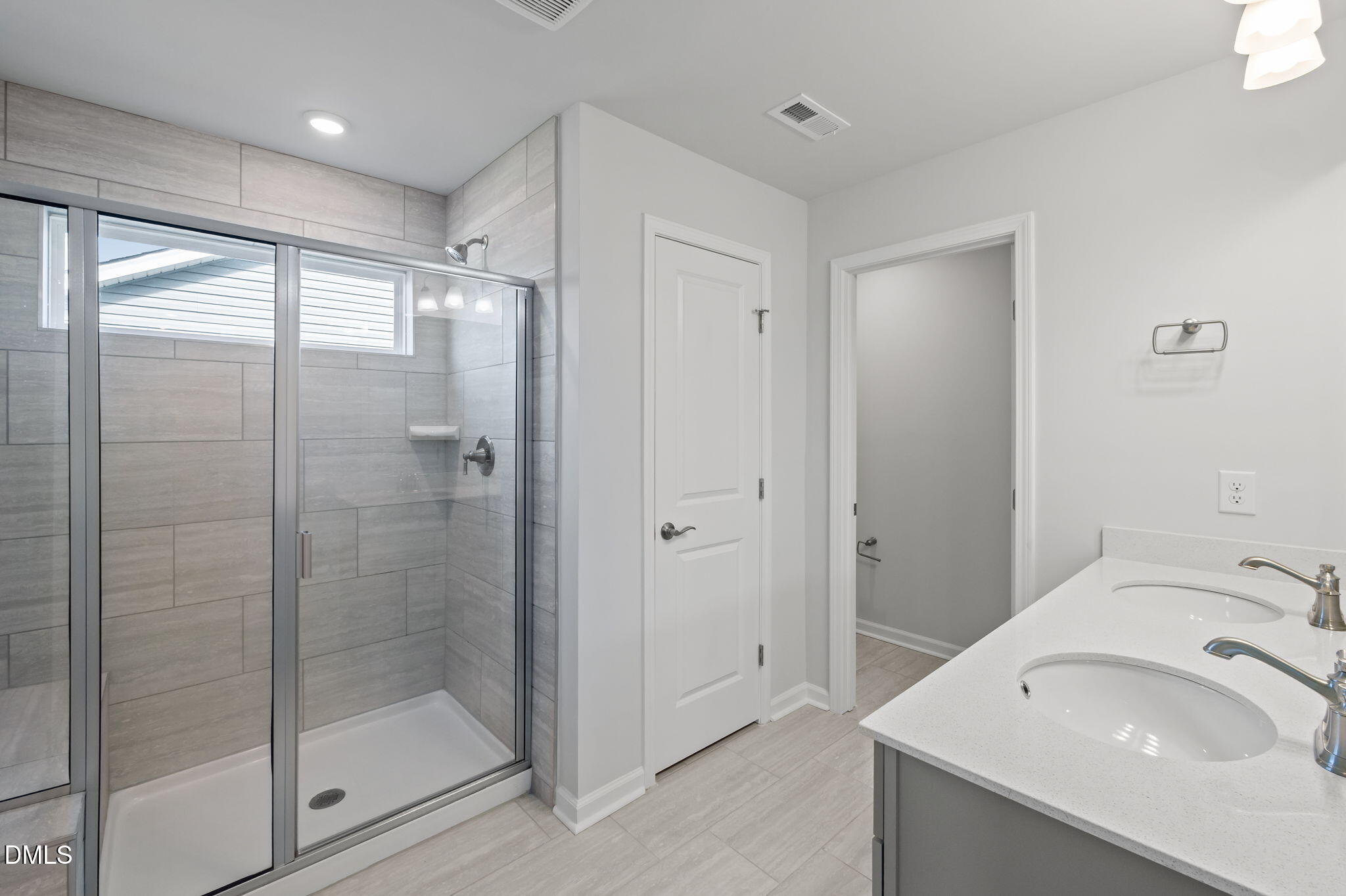 701 Mayfly Way Durham, NC 27703 - Photo 37 of 50 a bathroom with a shower sink and mirror