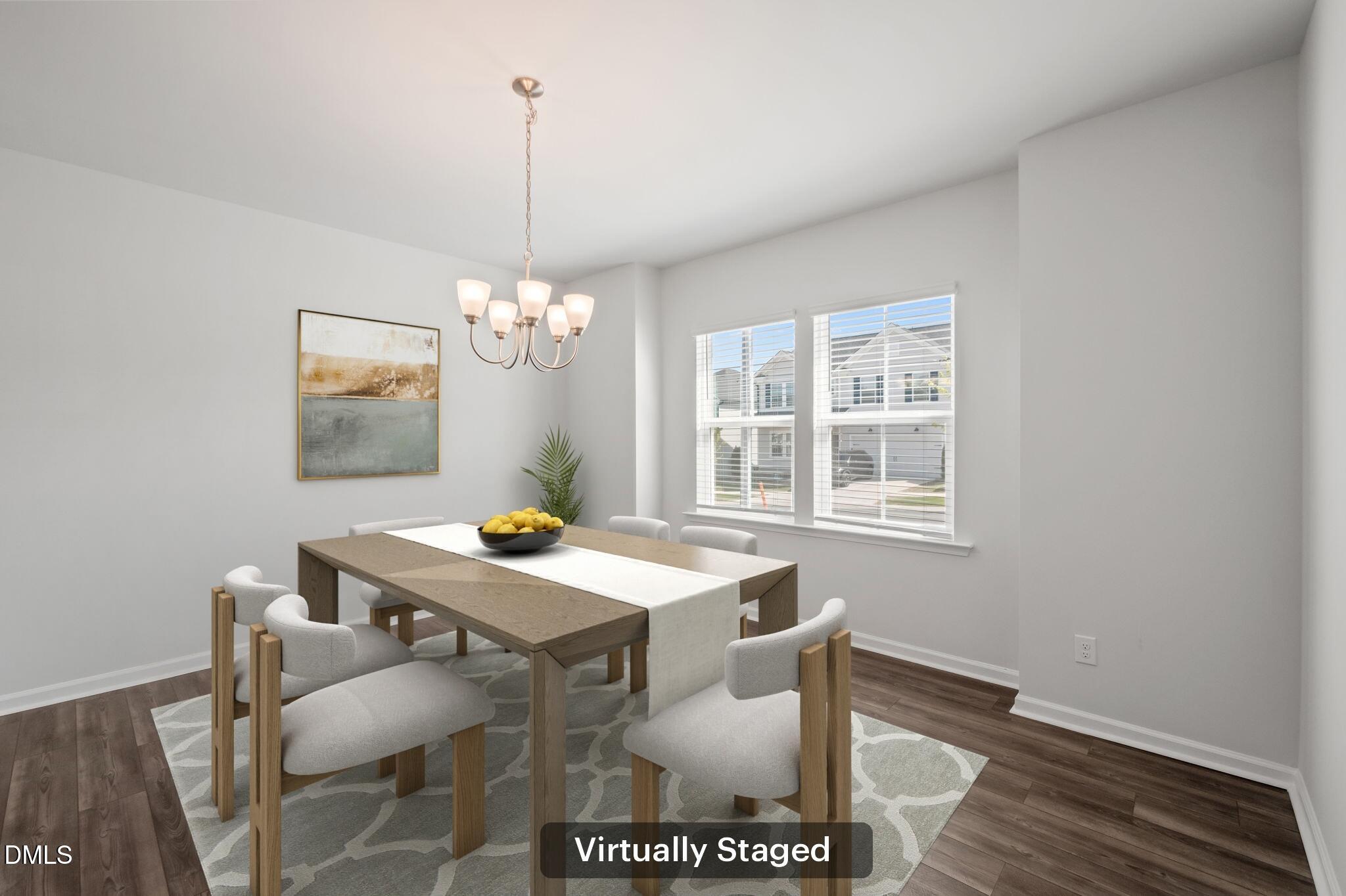 701 Mayfly Way Durham, NC 27703 - Photo 5 of 50 a view of a dining room with furniture a chandelier and wooden floor