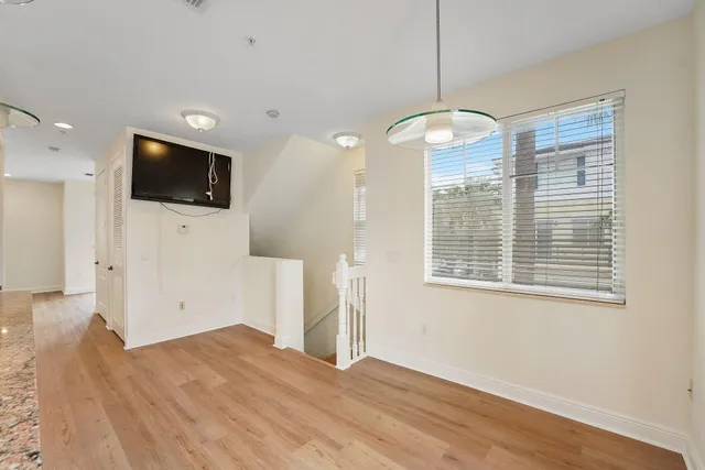 a bedroom with a bed and a flat tv screen on dresser