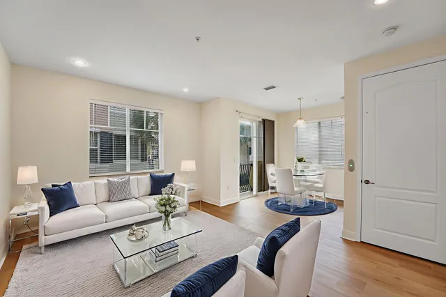 a view of a livingroom with wooden floor and windows