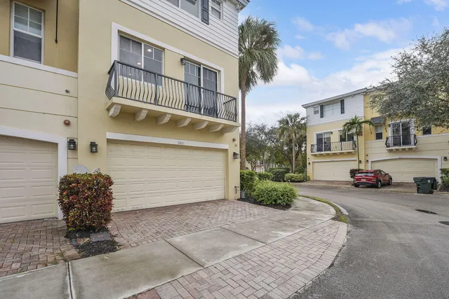 a view of a house with a yard and garage