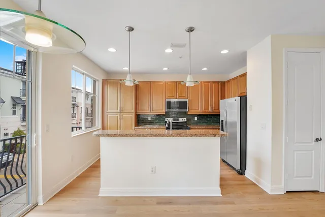 a view of kitchen with sink microwave refrigerator and outdoor view