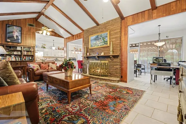 a living room with furniture a rug and a table