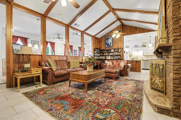 a living room with fireplace furniture and a flat screen tv