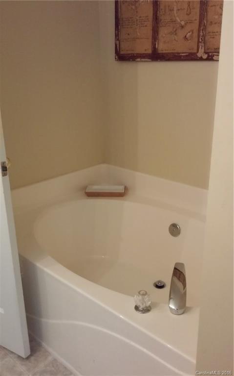 8445 Angwin Place Charlotte, NC 28262 - Photo 13 of 20 a bathroom with a tub