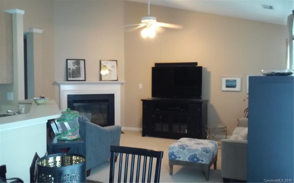 8445 Angwin Place Charlotte, NC 28262 - Photo 3 of 20 a living room with furniture and a fireplace