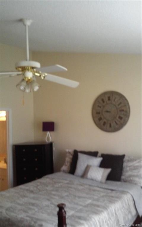 8445 Angwin Place Charlotte, NC 28262 - Photo 10 of 20 a bedroom with a bed and a table