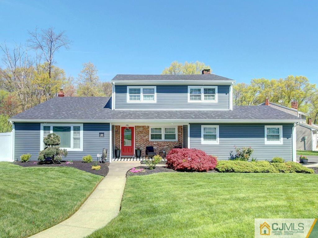 a front view of house with yard and green space