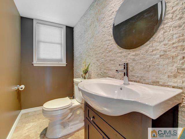 33 Thomas Road East Brunswick, NJ 08816 - Photo 11 of 28 a bathroom with a sink and a mirror
