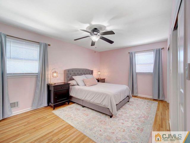 33 Thomas Road East Brunswick, NJ 08816 - Photo 15 of 28 a bedroom with a bed and a chandelier