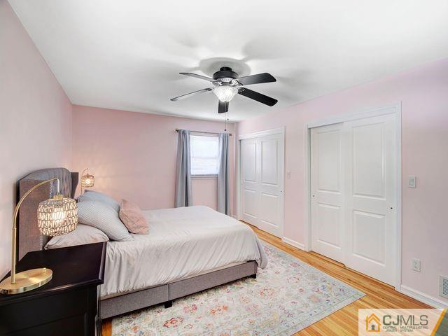 33 Thomas Road East Brunswick, NJ 08816 - Photo 16 of 28 a bedroom with a bed and a chandelier