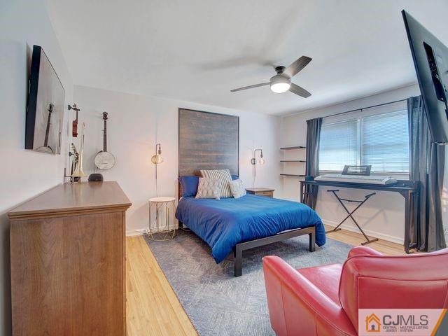 33 Thomas Road East Brunswick, NJ 08816 - Photo 18 of 28 a bedroom with furniture and a chandelier