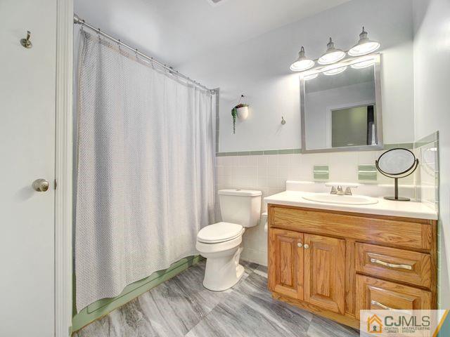 33 Thomas Road East Brunswick, NJ 08816 - Photo 20 of 28 a bathroom with a granite countertop toilet a sink and a mirror