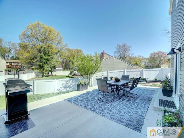 33 Thomas Road East Brunswick, NJ 08816 - Photo 22 of 28 a view of a patio with table and chairs potted plants with wooden floor