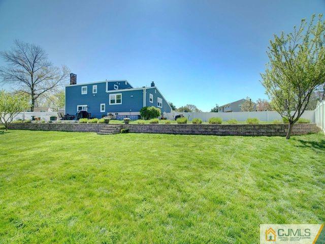 33 Thomas Road East Brunswick, NJ 08816 - Photo 24 of 28 a view of a house with a big yard