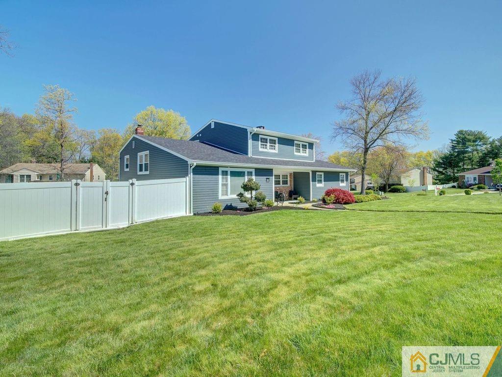 33 Thomas Road East Brunswick, NJ 08816 - Photo 27 of 28 a front view of a house with a garden and trees