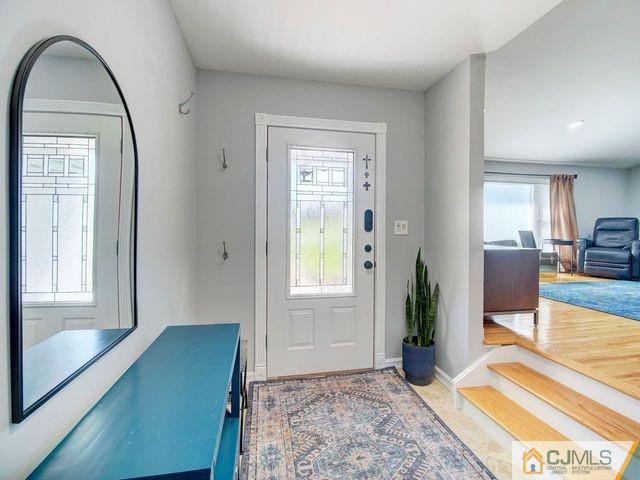 33 Thomas Road East Brunswick, NJ 08816 - Photo 3 of 28 a view of an entryway with wooden floor and a livingroom